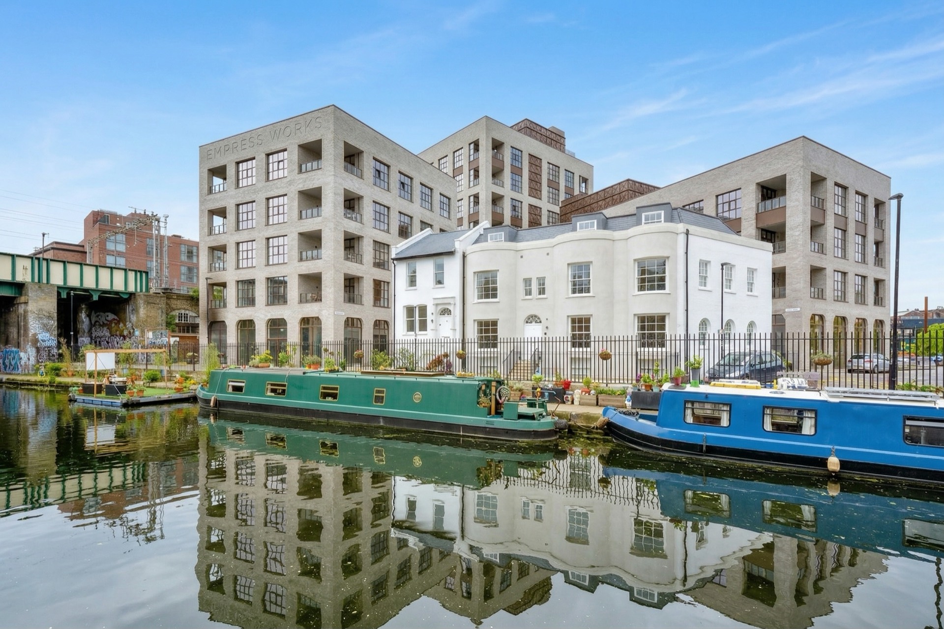 Empress Works seen across the Regent's Canal, narrowboats moored on the towpath