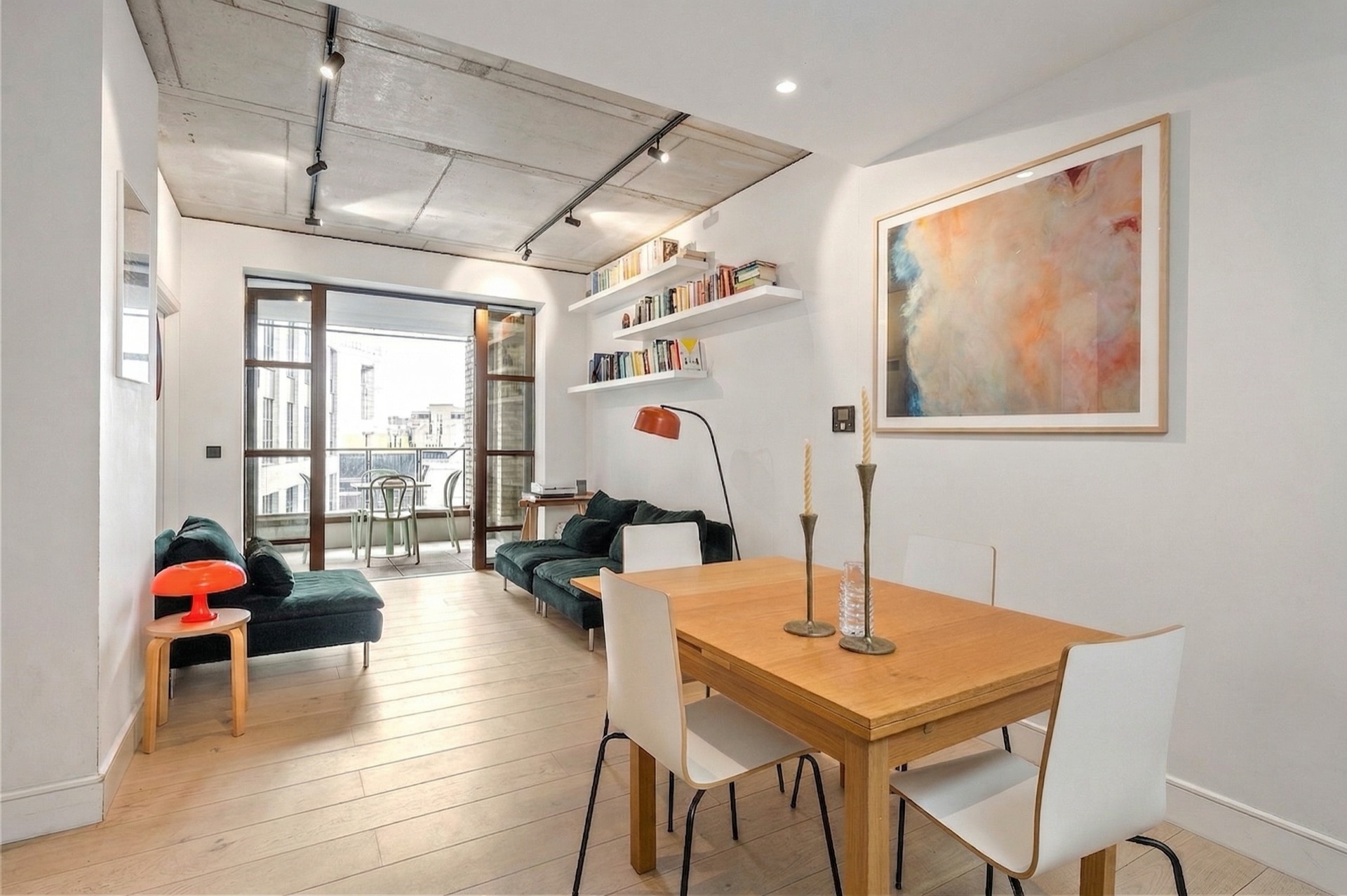 Open-plan living and dining room with the balcony beyond