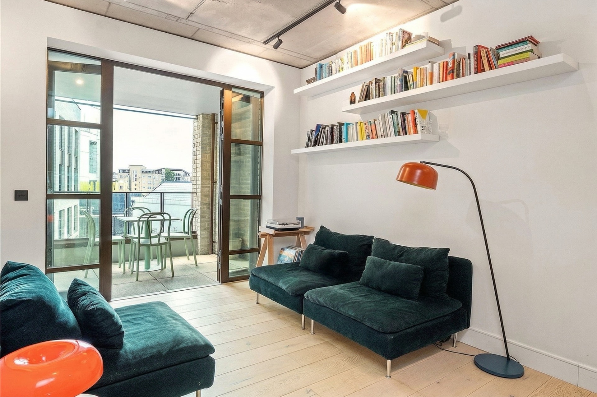 Living room with shelving and open balcony doors