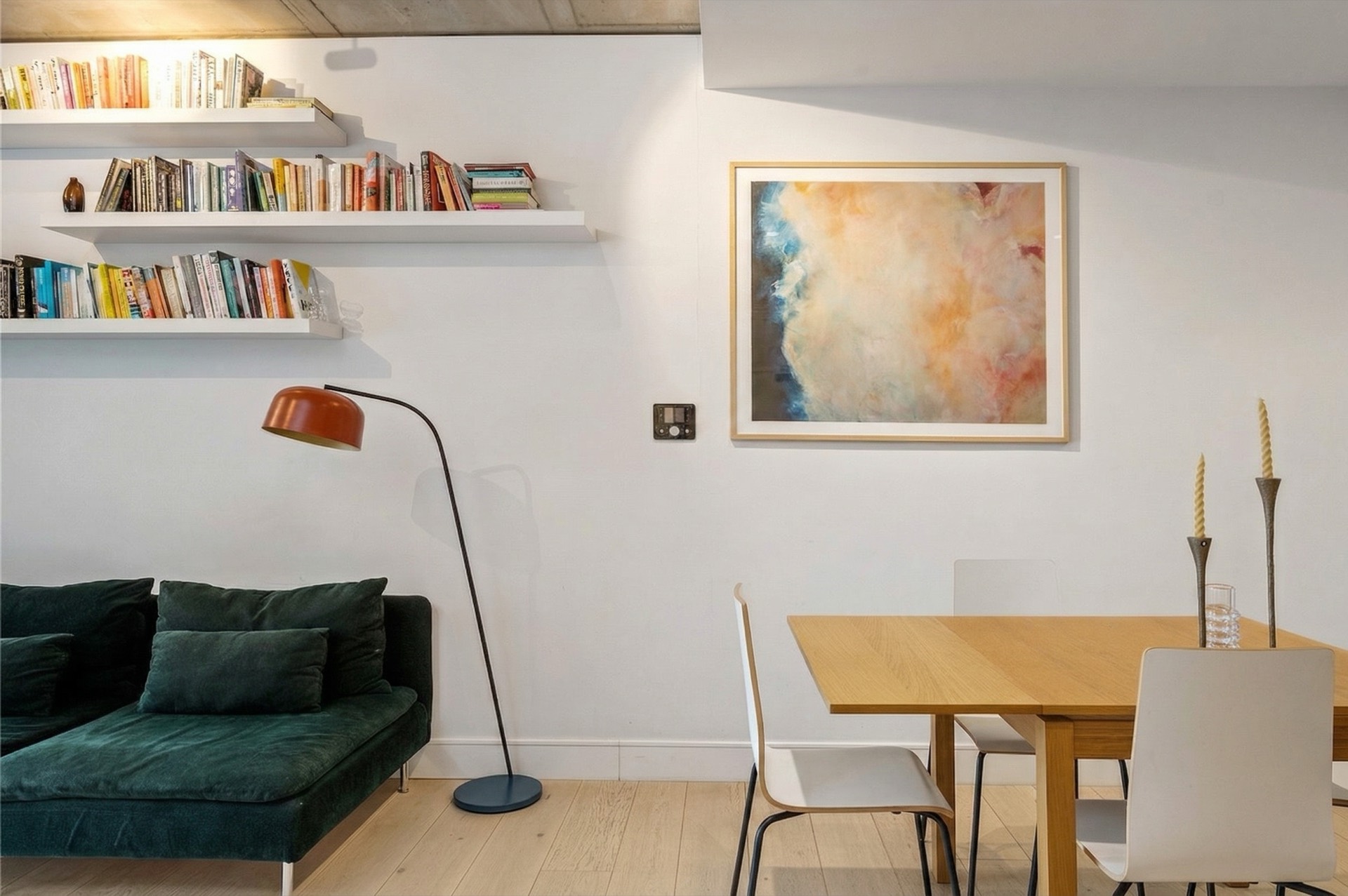 Living room detail: artwork, floor lamp and dining table