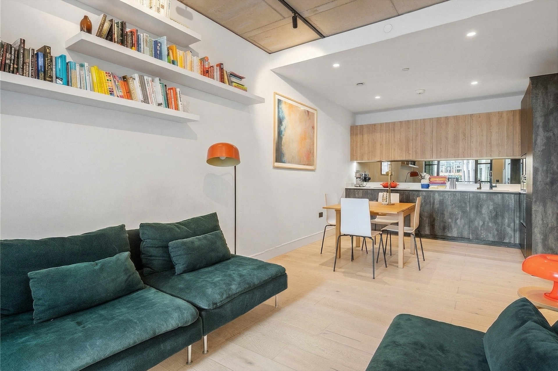 Kitchen with timber cabinetry, mirrored splashback and dining table